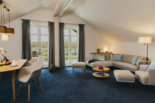 a living room with a couch and a table at Gutshof Sagmühle in Bad Griesbach