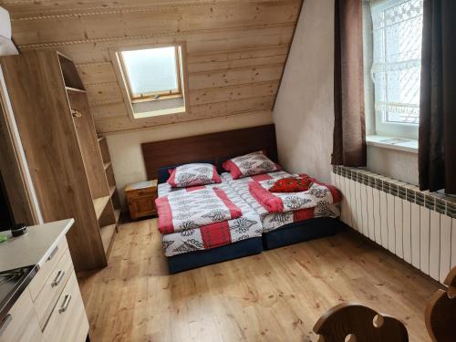 a bedroom with a bed in a small room at Agroturystyka Piekielnik in Piekielnik