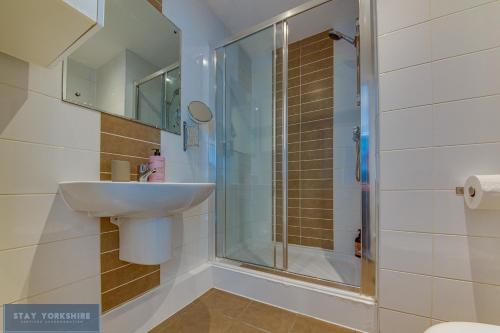 a bathroom with a sink and a shower at Stay Yorkshire Hamilton Mews Apartment in Doncaster