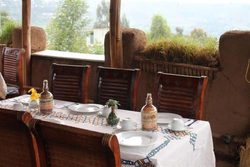 a table with a white table cloth on a table with a view at Lodge Du Chateau in Gonder