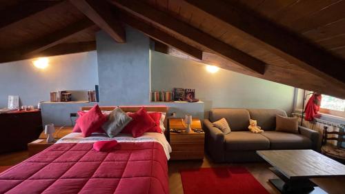 a bedroom with a large bed and a couch at Alba sul lago B&B in Stresa