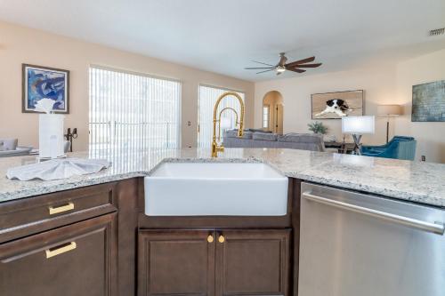 a kitchen with a white sink and a living room at 126NHD - Stevensons Place (G) in Davenport