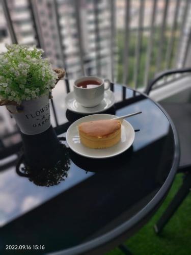 a table with a plate of food and a cup of coffee at Damai Homestay Almyra in Kajang