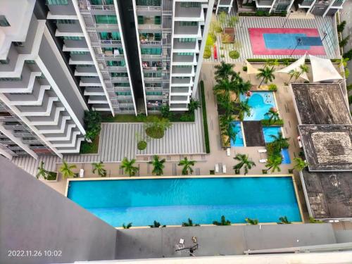 an overhead view of an apartment complex with a swimming pool at Damai Homestay Almyra in Kajang