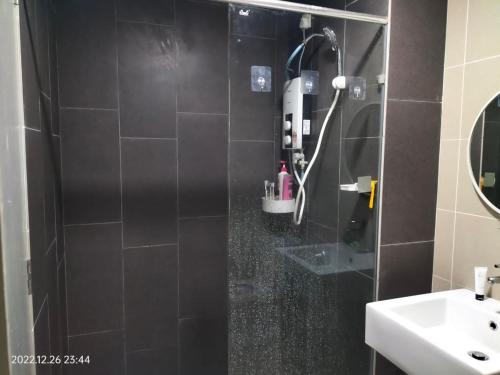 a bathroom with a shower and a sink at Damai Homestay Almyra in Kajang