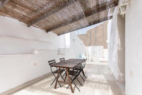 a dining room with a wooden table and chairs at Guest House Sicily in Syracuse