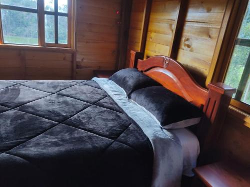 Una cama o camas en una habitación de HOTEL CABAÑAS SANTO TOMAS