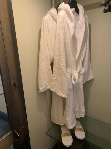 a group of white towels hanging on a wall at Borgoloto Suite 17 in San Marino