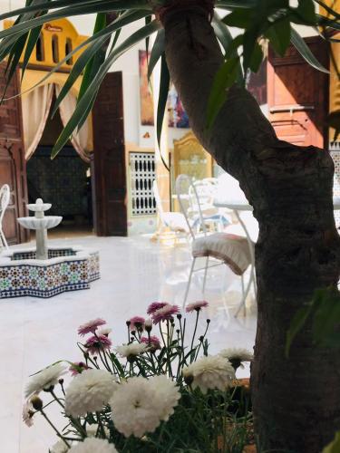 a bunch of flowers sitting next to a tree at RIAD ESMERALDA By Dar Ouezzani in Rabat