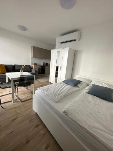 a bedroom with two beds and a table in it at A 212, apartments in the heart of Budapest in Budapest