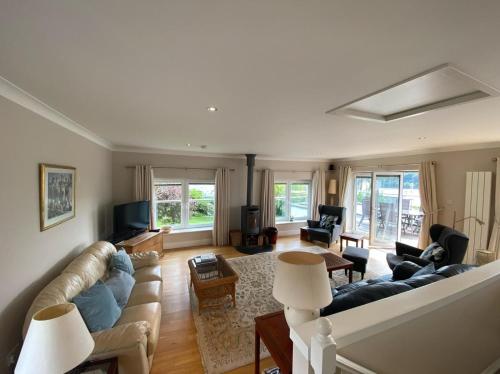 a living room with a couch and a tv at Phoenix Cottage in Kippford