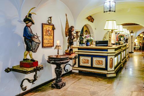 a room with a statue of a man on a pedestal at Atlas Grand Hotel in Garmisch-Partenkirchen