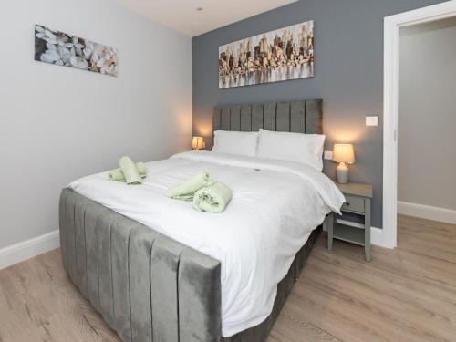 a bedroom with a large bed with towels on it at Pass the Keys Brand New Stylish 2BR Flat in Reading Centre in Reading