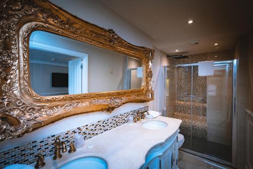a bathroom with a large mirror and a sink at The Little Inn at Grasmere in Grasmere