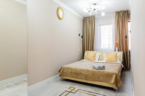Postel nebo postele na pokoji v ubytování Квартира на высоком этаже ЖК Евразия