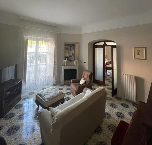 a living room with a couch and a chair at La casa di Cinzia, Pompei/Vesuvio in Palma Campania