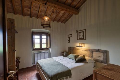 a bedroom with a large bed in a room at La Casa Di Campagna in Magione