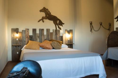 a bedroom with a bed with a horse on the wall at La Casa Di Campagna in Magione