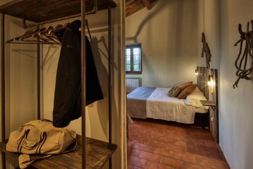 a bedroom with a bed and a mirror in a room at La Casa Di Campagna in Magione