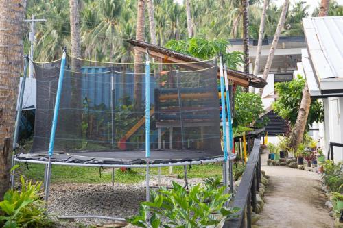 a chair in a yard with a net at Surigao Dream Beach Resort in Tigbao