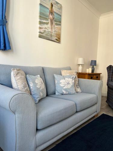 a living room with a gray couch with pillows at Keepers Rest Apartment - Scarborough in Scarborough