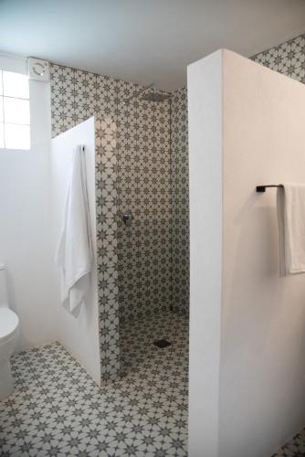a bathroom with a shower and a toilet at Casa Naâmja in Tepoztlán