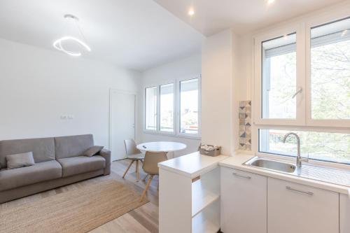 a kitchen and living room with a couch and a sink at Malibò, Bologna By Short Holidays in Bologna
