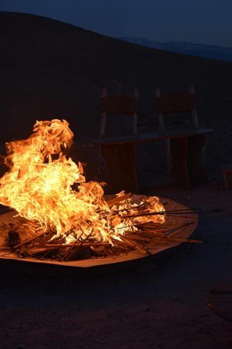 a fire is burning on a grill in the dark at Camp Cameleon in Marrakech