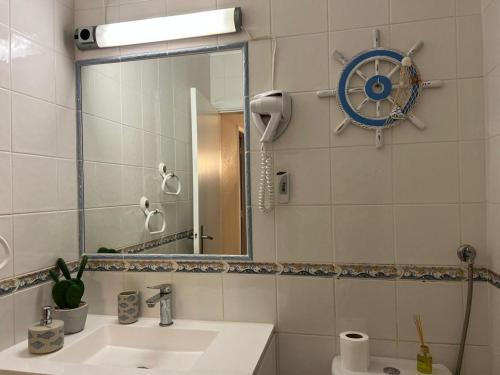 a bathroom with a sink and a mirror at Lagos Apartment Sea View in Lagos