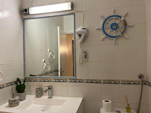 a bathroom with a sink and a mirror at Lagos Apartment Ocean View in Lagos