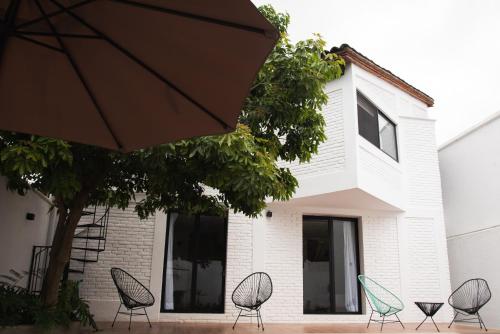 a group of chairs sitting in front of a building at Casa Naâmja in Tepoztlán