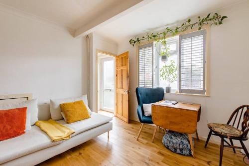 a living room with a couch and a table at Littlehaven in Roffey