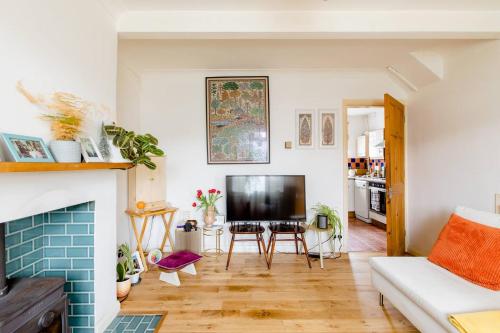 a living room with a couch and a fireplace at Littlehaven in Roffey