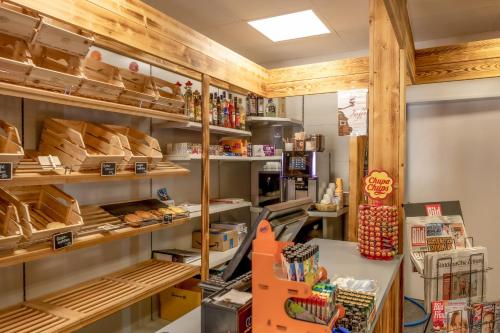 a bakery with wooden ceilings and shelves with food at Season Camper 700 in Löwenstein