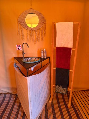 a bathroom with a sink and a mirror at Camp Cameleon in Marrakech