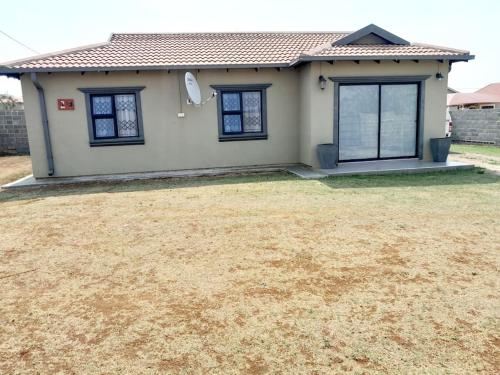 a small house with a yard in front of it at Inkazimulo Airbnb in Estcourt