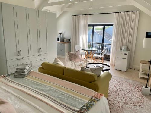 a living room with a green couch and a table at African Flame Apartment in Knysna