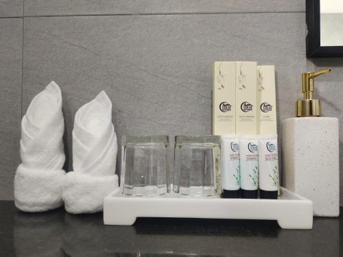a shelf with toiletries and towels on a bathroom counter at H&M Boutique in Kampot