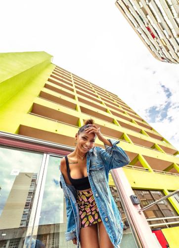 a woman is standing in front of a building at Now Benidorm in Benidorm