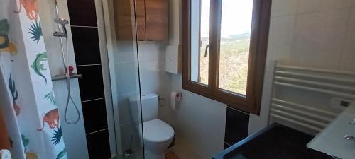 a bathroom with a toilet and a glass shower at Le Panorama - Panoramic mountain view - very very quiet in Saint-Antonin