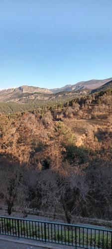 a fence on the side of a road in a field at Le Panorama - Panoramic mountain view - very very quiet in Saint-Antonin