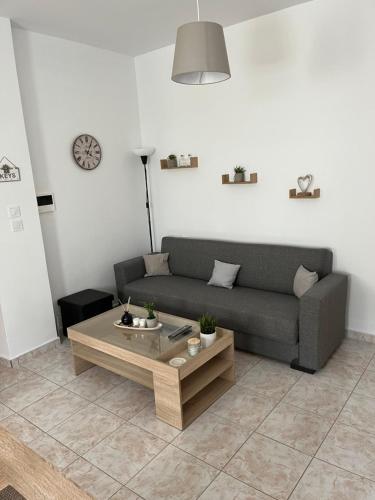 a living room with a couch and a coffee table at G.S Ialysos Holiday Apartment in Ialyssos
