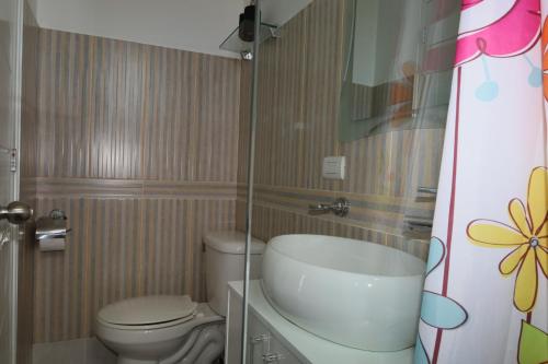 a small bathroom with a toilet and a sink at Venere Bayahibe by Mireya in Bayahibe