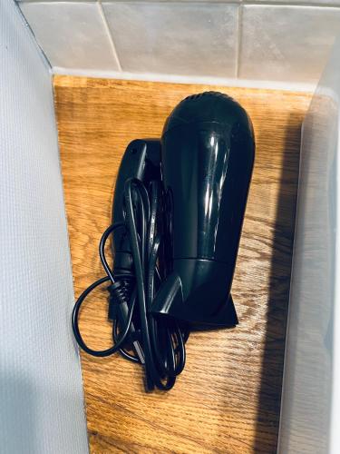 a pair of black dishes sitting on a table at Studio Remigny, hyper centre ville de Nevers, style "Appart-hôtel" by PRIMO C0NCIERGERIE in Nevers