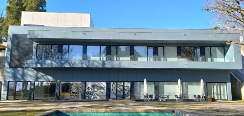 a modern house with glass doors and windows at Albergue de Santa Luzia in Viana do Castelo