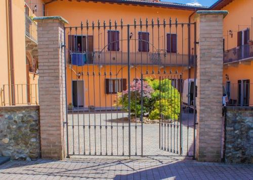 an iron gate in front of a building at Il Monastero in Castelletto sopra Ticino