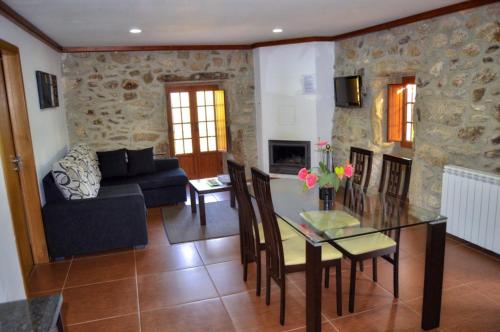 a living room with a glass table and a couch at Casa da Laranjeira in Barbeitos