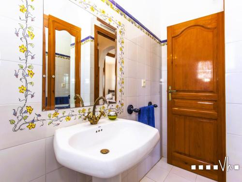 a bathroom with a white sink and a mirror at VH CostaBlanca - OSALVA in Benissa