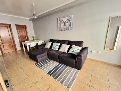 a living room with a couch and a table at Spacious Chalet Next to the Sea - Airport in San Isidro