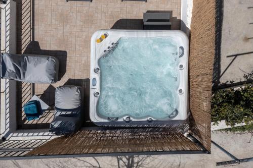 an overhead view of a bath tub on a building at House Aggeliki Private Hot Tub in Kissós